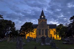 The Dornoch Cathedral and cemetery have a moody ambiance at dusk in Dornoch, a town in the Highlands of Scotland, on July 3, 2026.