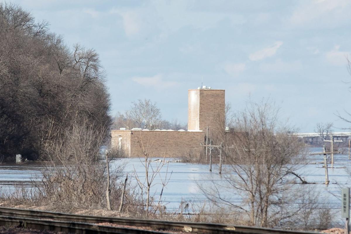 In Plattsmouth as the river rises tired, dry and sandbagging to save