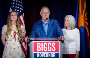 Gubernatorial Republican candidate Andy Biggs is surrounded by his daughter Mylie Biggs (left) and his wife, Cindy Biggs, as he