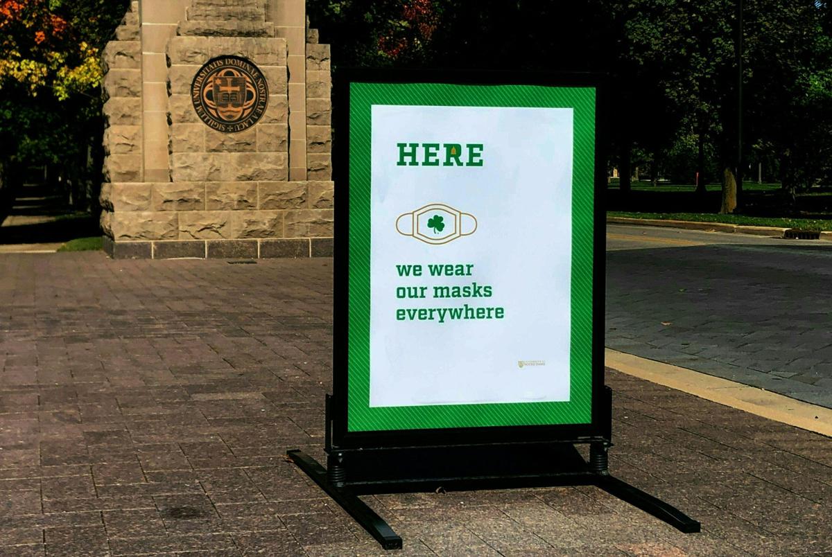 A sign asking to wear masks is seen on the campus of Notre Dame University in South Bend, Indiana on October 6, 2020. In June, Laurence Steinberg, a professor of psychology at Temple University, predicted that students returning to college campuses during a pandemic would not go well.