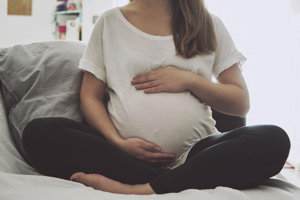 Pregnant woman touching her belly (copy)