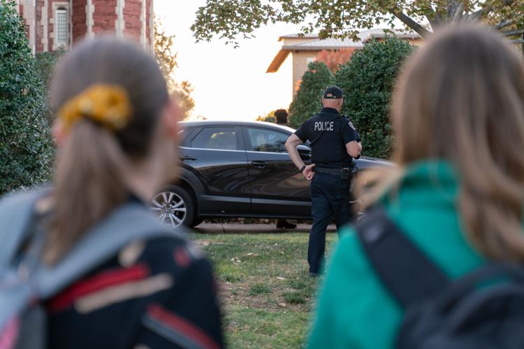 Students pass by stuck Mazda SUV