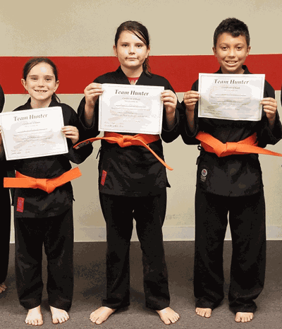 Local karate students earn orange belts