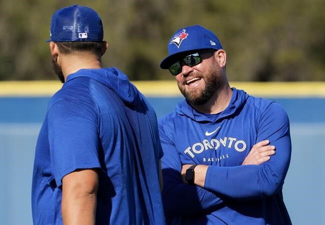 Toronto Blue Jays manager John Schneider (L) and bench coach Don