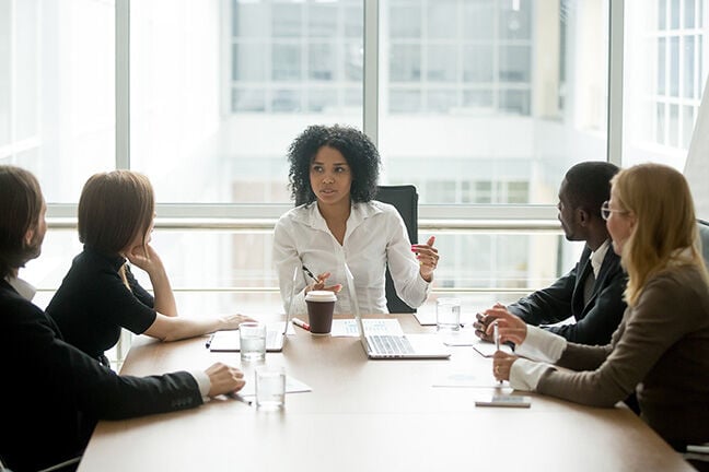 female boss leading corporate meeting
