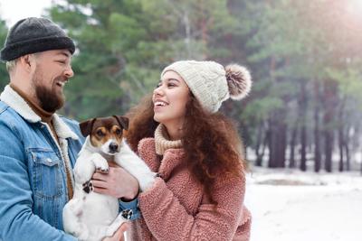 Happy,Young,Couple,With,Dog,In,Forest,On,Winter,Day