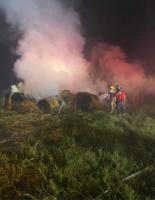 Emergency crews battle hay fire
