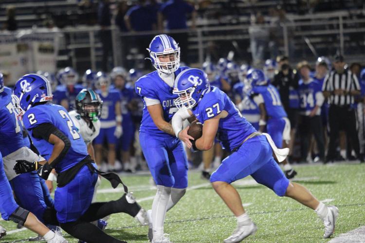 Oldham County's Derek Dees hands the ball off to Nash Meredith