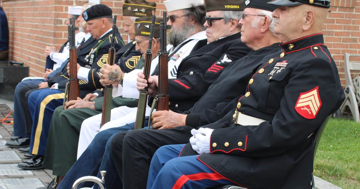 A somber ceremony as rain holds off