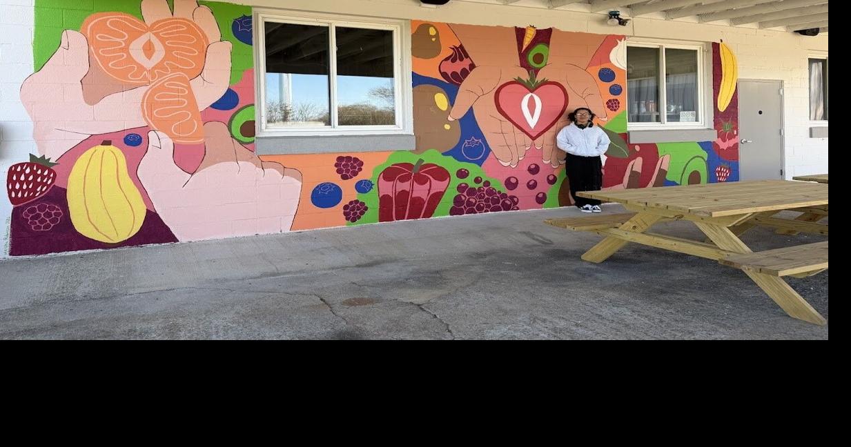 Local high school senior donates spring break to paint mural at Agape Center