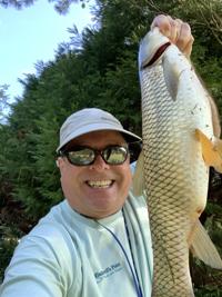 Mount Pleasant angler catches elusive carp while fly fishing with 'Mopey Opie'