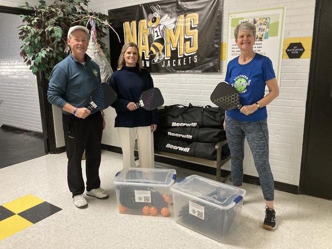 Ben Lacy, Coach Bush, and Beth Eberhard with PB equipment donated to NA Middle.jpg