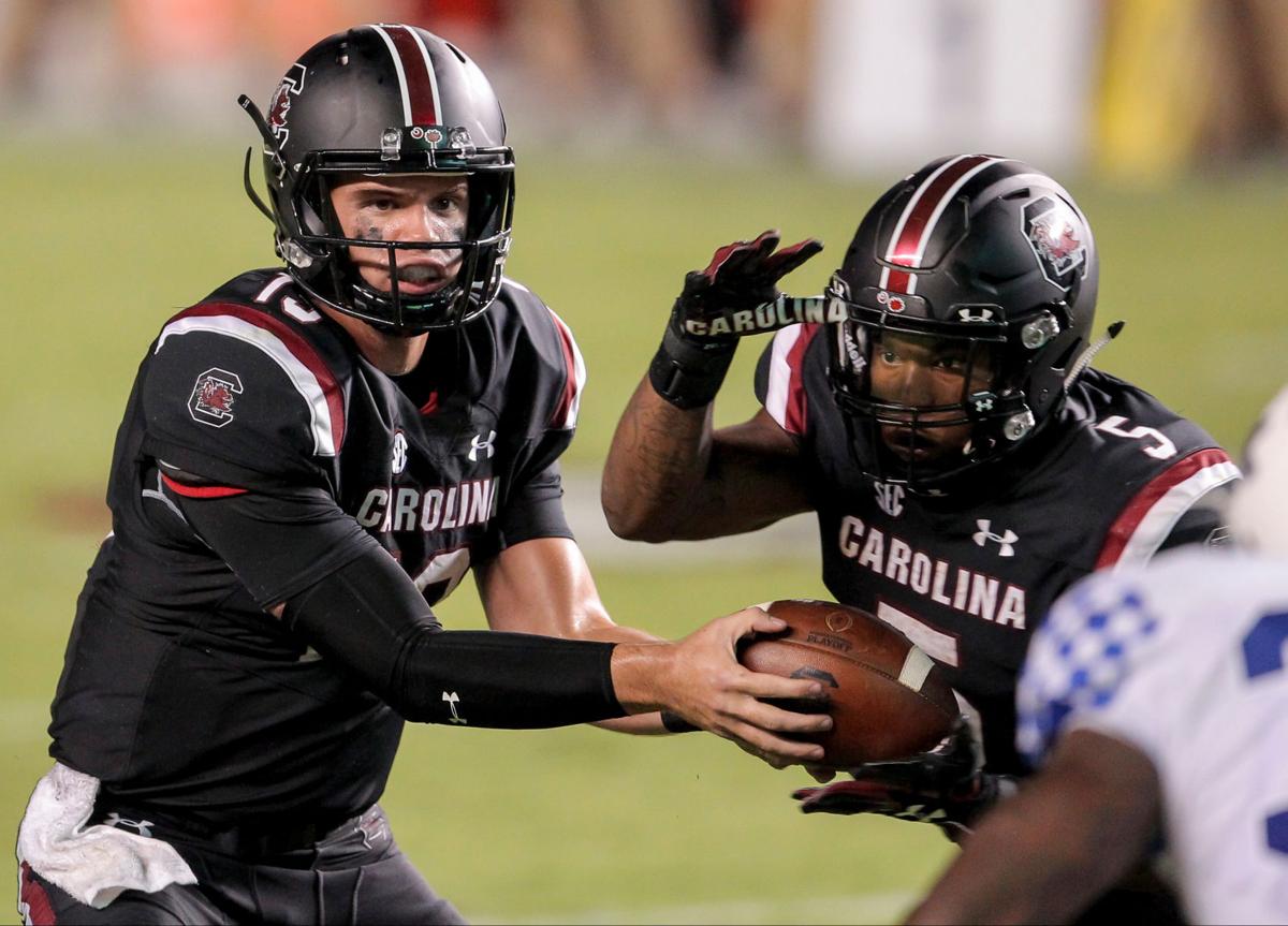 South Carolina running backs coach Bobby Bentley with help from