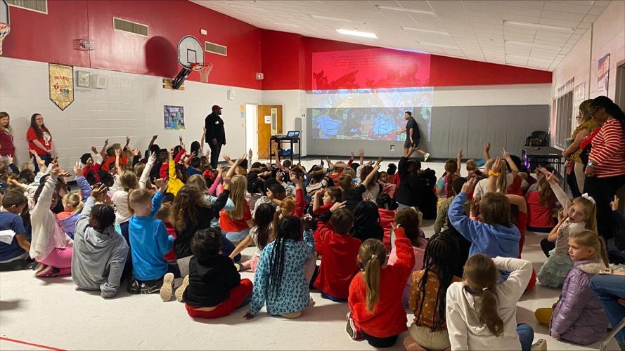 Past USC football players read their book to Aiken students