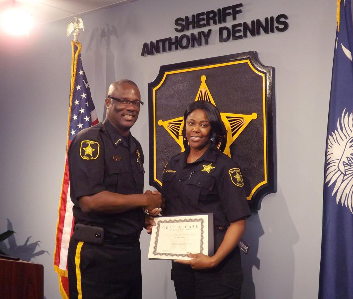 Photo of Sumter County Sheriff Anthony Dennis awarding certificate to former Lt. Melissa Addison