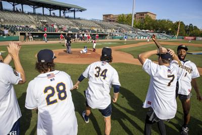 RiverDogs players cheer on youth baseball