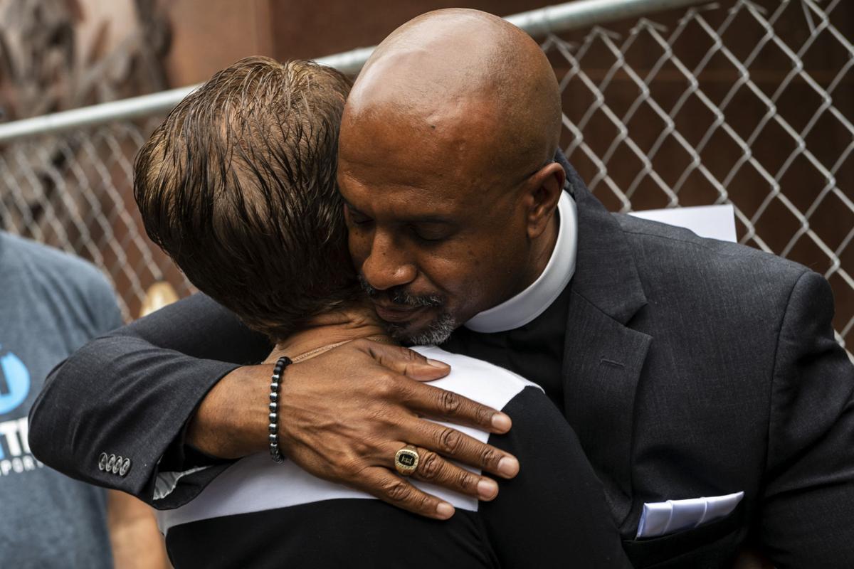 Eric Manning embraces woman at Tree of Life