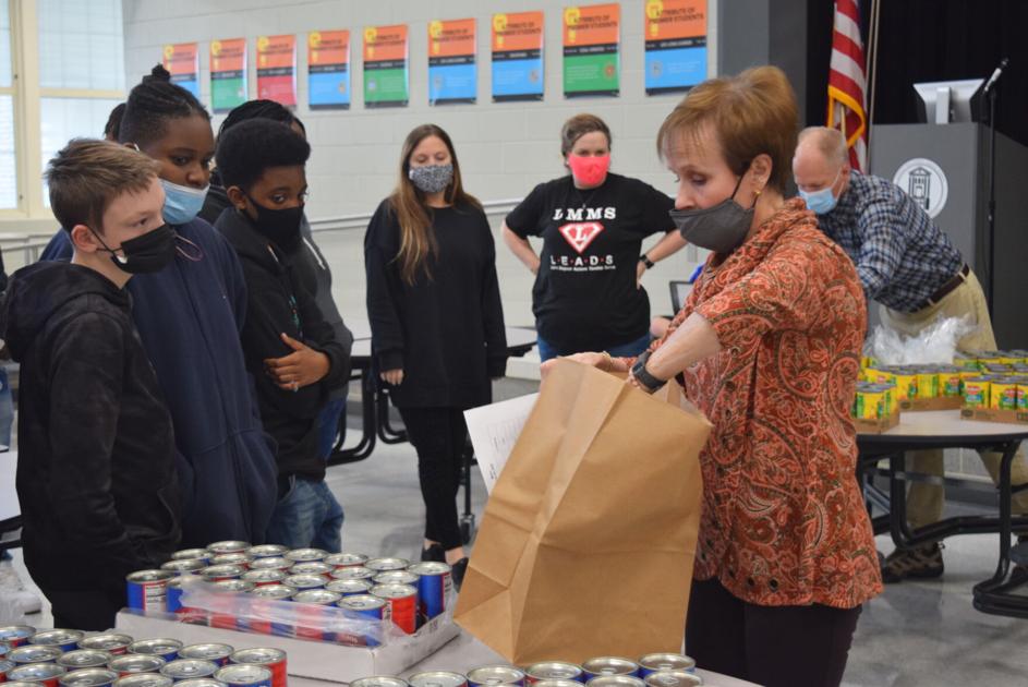 Leavelle McCampbell student volunteers pack bags full of food for Graniteville community