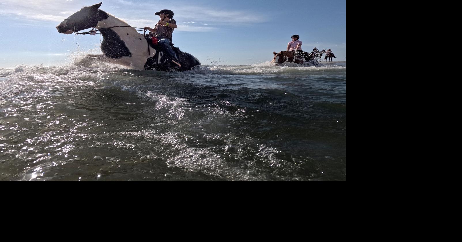 Horses, through the swash to the bar, fill the beach for the annual Heart Association’s Beach Ride