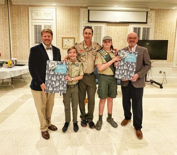 Two scouts receive laptops from Computers with a Cause
