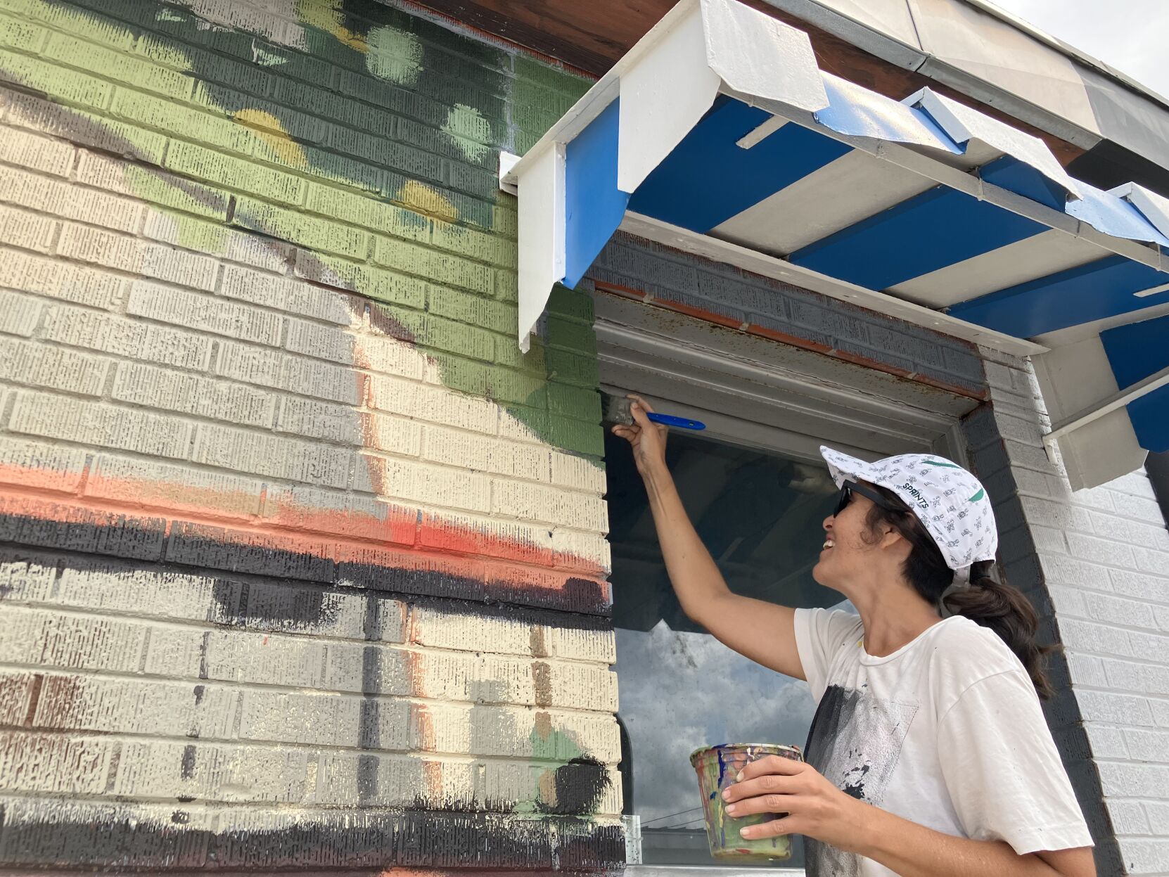 Muralists memorialize Lake City fruit stand owner during