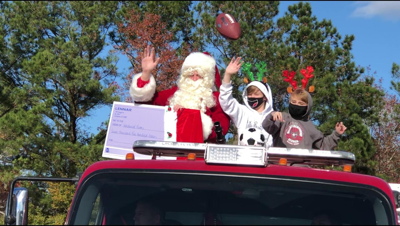 Jason Byham and Santa and his two “reindeer helper” sons end the Christmas parade at Windwood Farm Home for Children.