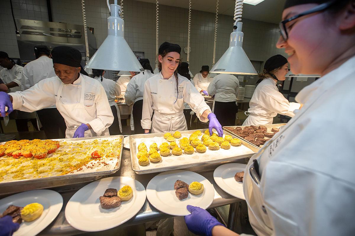 Culinary Institute of Charleston students plate food for the dinner.jpg