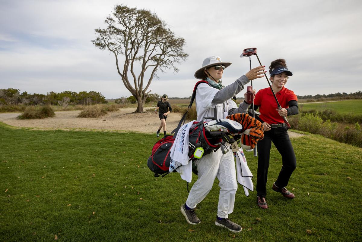 Mollly takes putter.jpg
