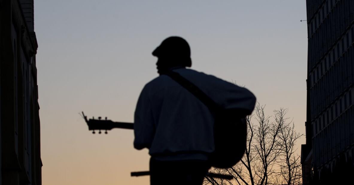 Photos: Charleston musician takes guitar performance backwards on a bike