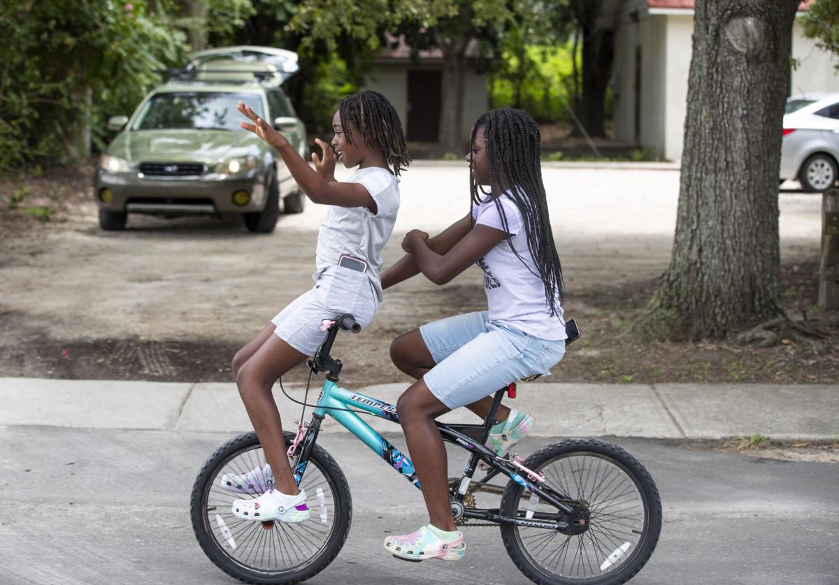 Rosemont Neighborhood Girls Riding Handlebars on Bike.JPG