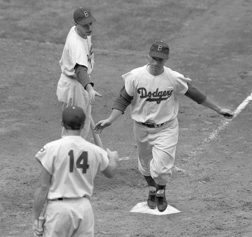 This image features six Brooklyn Dodgers in the dugout of