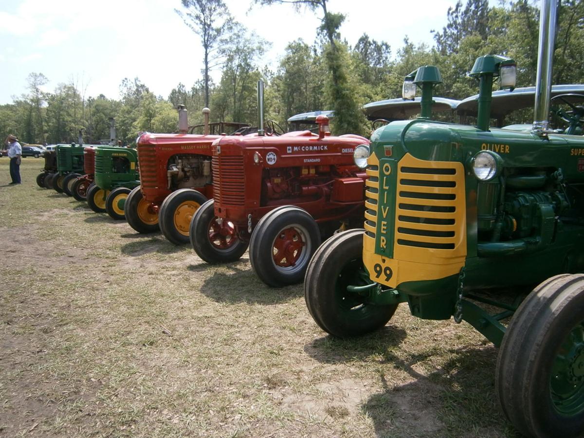 Antique farm equipment, autos line field in Adams Run for tractor show