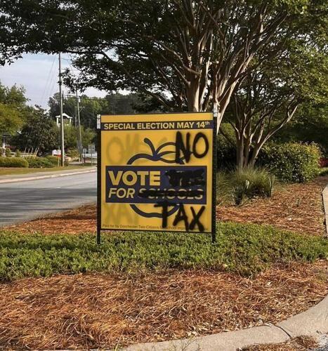 No Tax graffiti scrawled on campaign signs for DD2's No-Tax-Increase Bond Referendum