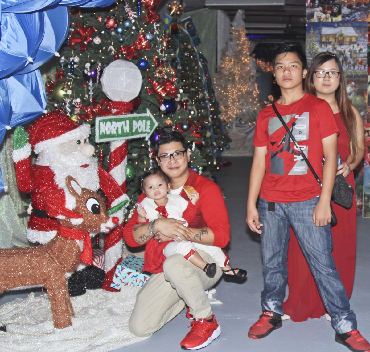 jerry solangon kneeling poses for a photo with family at the christmas dream display on dec 1 the christmas themed display located on the second - A Dream For Christmas jerry solangon kneeling poses for a photo with family at the christmas dream display on dec 1 the christmas themed display located on the second - A Dream For Christmas