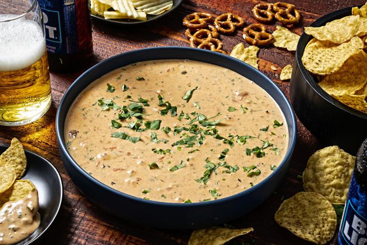 This queso is a cheesy dip that begs for another scoop