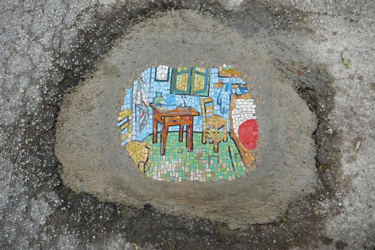 Rogue artist fills city potholes with mosaics and social commentary 1