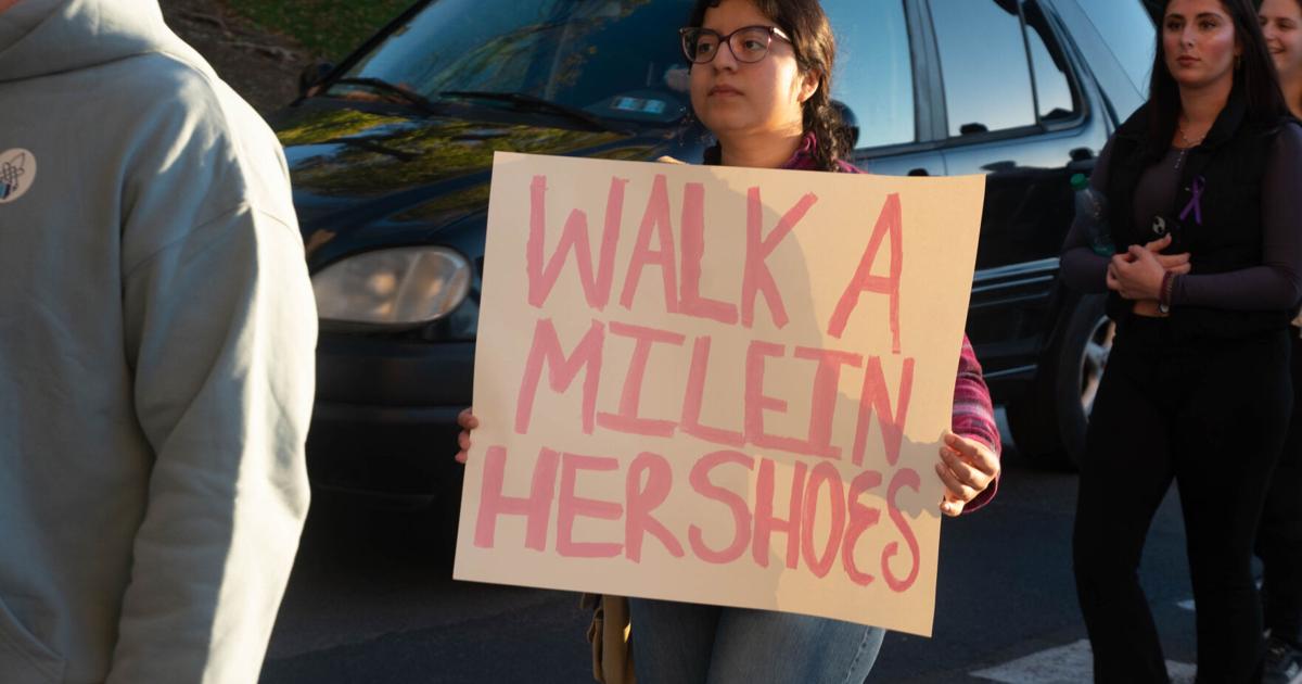 Footwear Checklist.pdf walk a mile in her shoes, student with sign 2 | | psucollegian.com