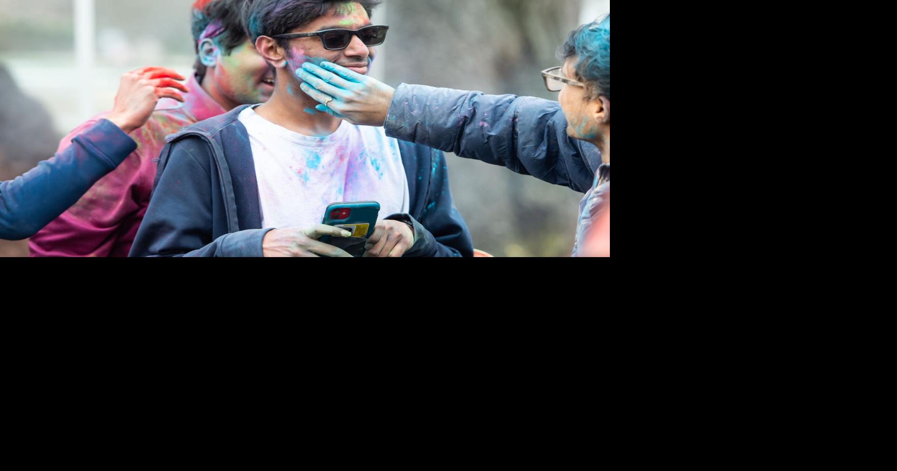3/26/22 Holi Celebration, Varun Kumar has colors applied to his face Campus