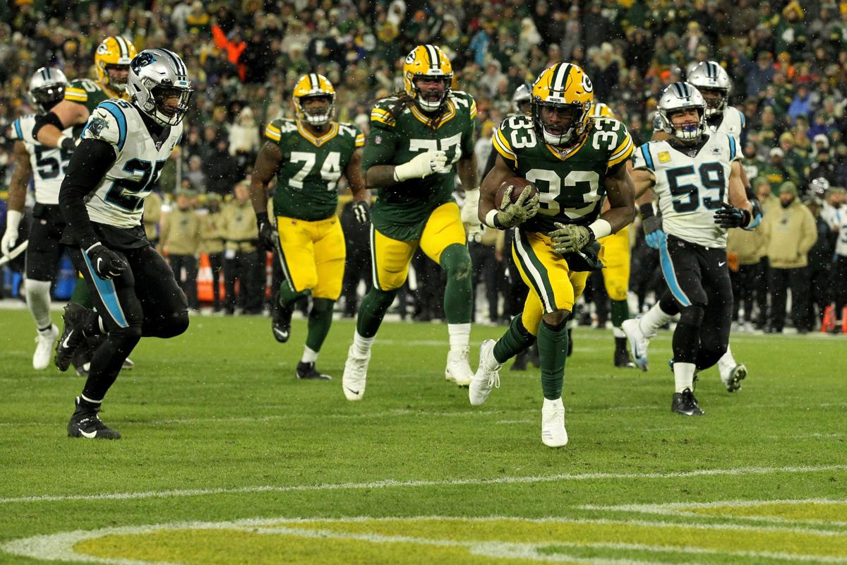 Aaron Jones (33) of the Green Bay Packers scores a touchdown against the Carolina Panthers in the game at Lambeau Field on November 10, 2019 in Green Bay, Wisconsin.