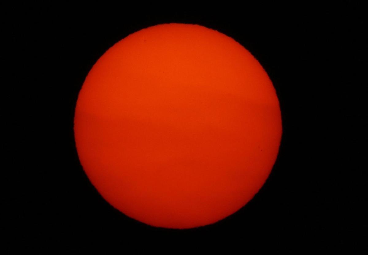 The setting red sun is visible in Chicago