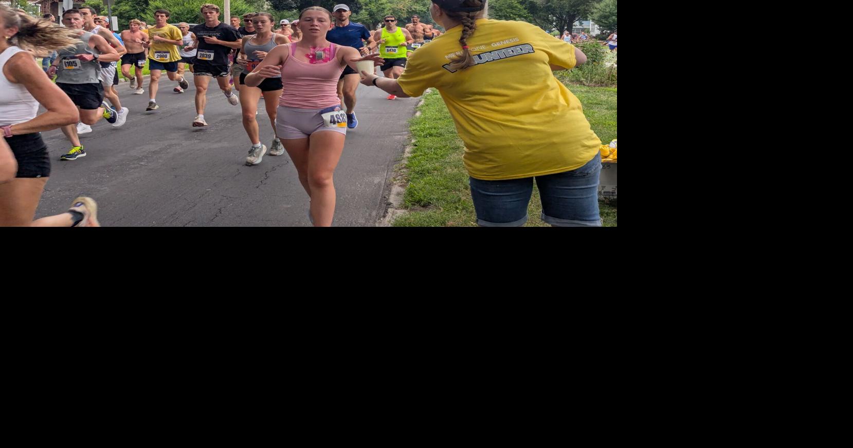 How to hand out water without losing an arm — and other Bix 7 volunteer action