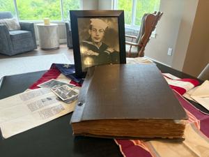 Son gifting dad's scrapbook of WWII memories to QC Veteran Outreach Center