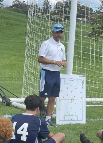 Coach Javier Velasco running through plays