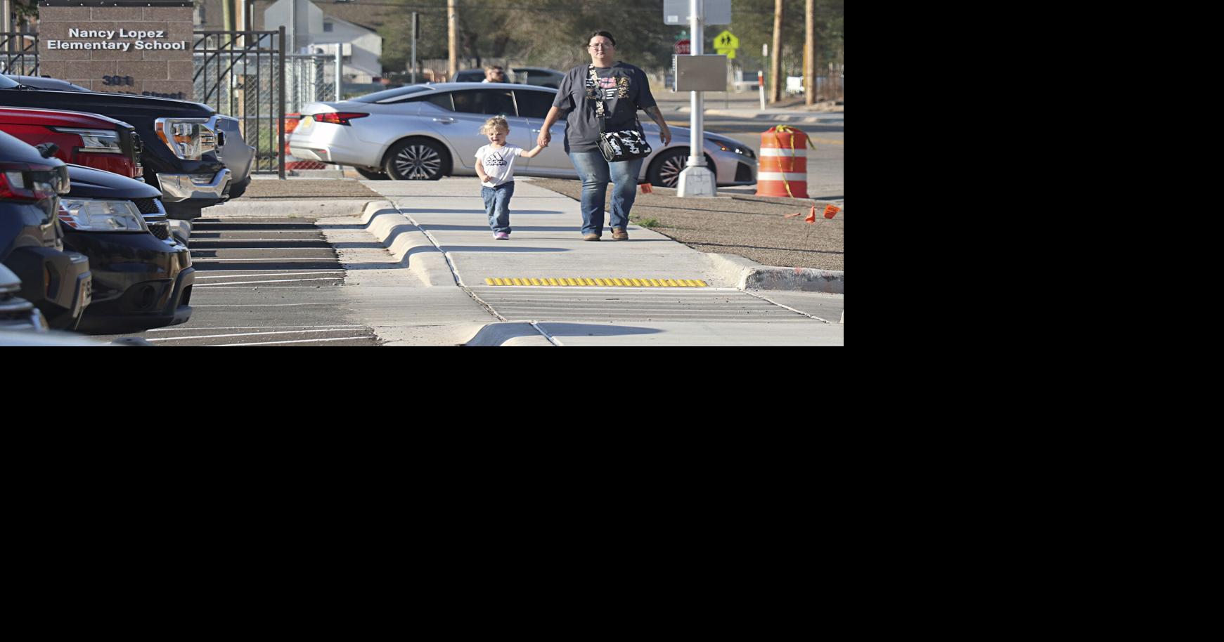 Woman and child walking by Nancy Lopez ES