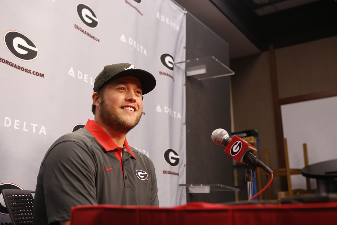 Georgia quarterback Matthew Stafford holds up his Detroit Lions