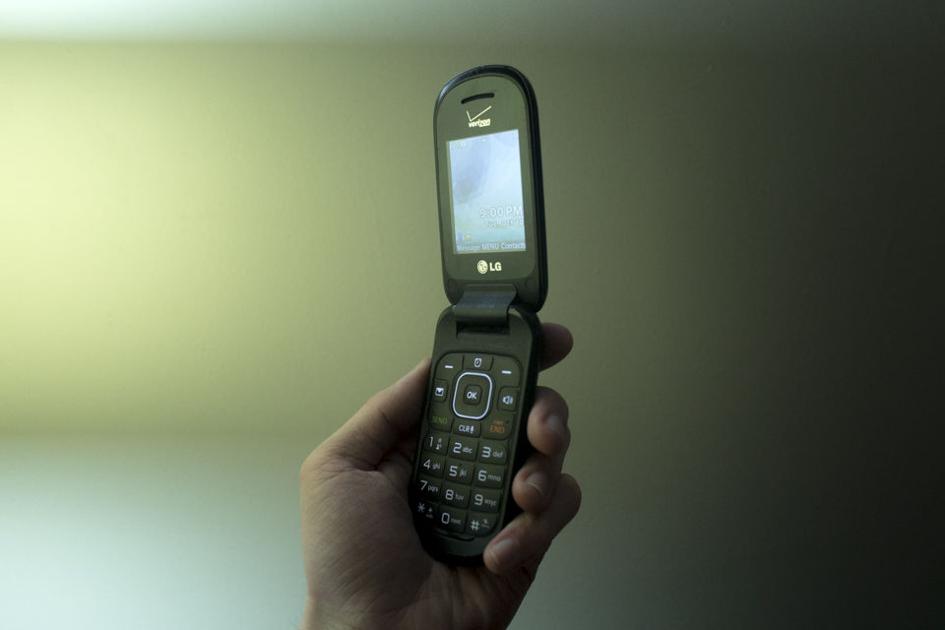 A Student Using A Flip Phone In 2022