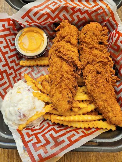 The chicken tenders plate with potato salad and fries.
