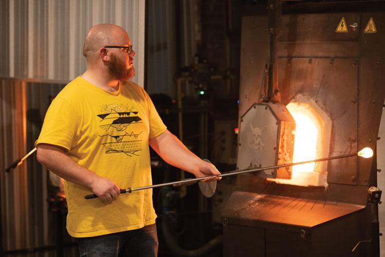 In an old Farmville gas station, raw material plus fire equals art