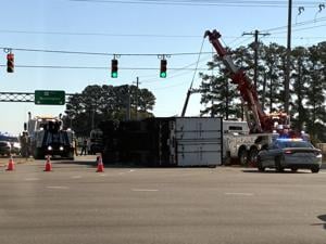 Driver charged in crash that overturned tractor-trailer