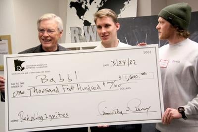 Tim Penny presents check to Babbl